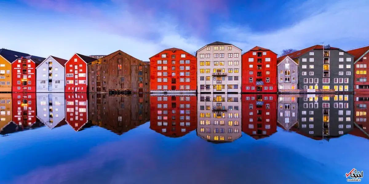 تصویری رویایی از انعکاس تصویر خانه‌ها بر روی رودخانه‌ای در تروندهایم نروژ