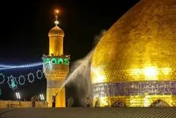 شستشوی گنبد طلای حرم امیرالمومنین(ع)/تصاویر