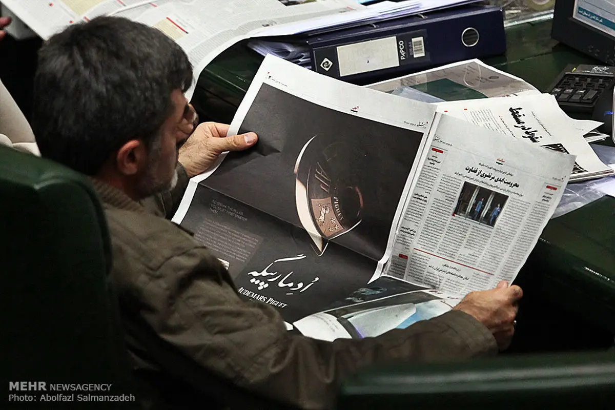 مهدی کوچک زاده در حال مطالعه روزنامه شرق در صحن علنی مجلس/ عکس