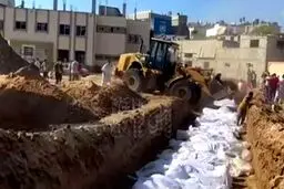 تدفین تلخ و سریع شهدا با لودر در گور دسته جمعی در غزه